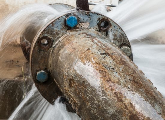 metal pipe with valve is leaking in water treatment plant