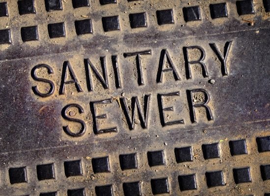 Sanitary sewer man hole cover iron lid with texture and grunge